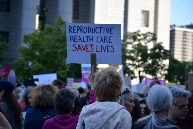 woman holding a sign at a protest